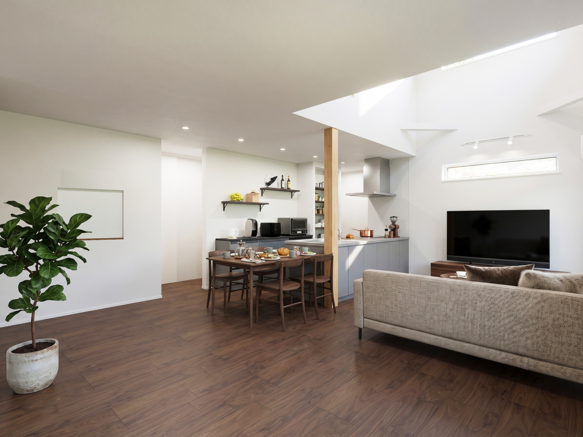 Open-concept living area with a dining table, kitchen in the background, and a large TV on the right edge.