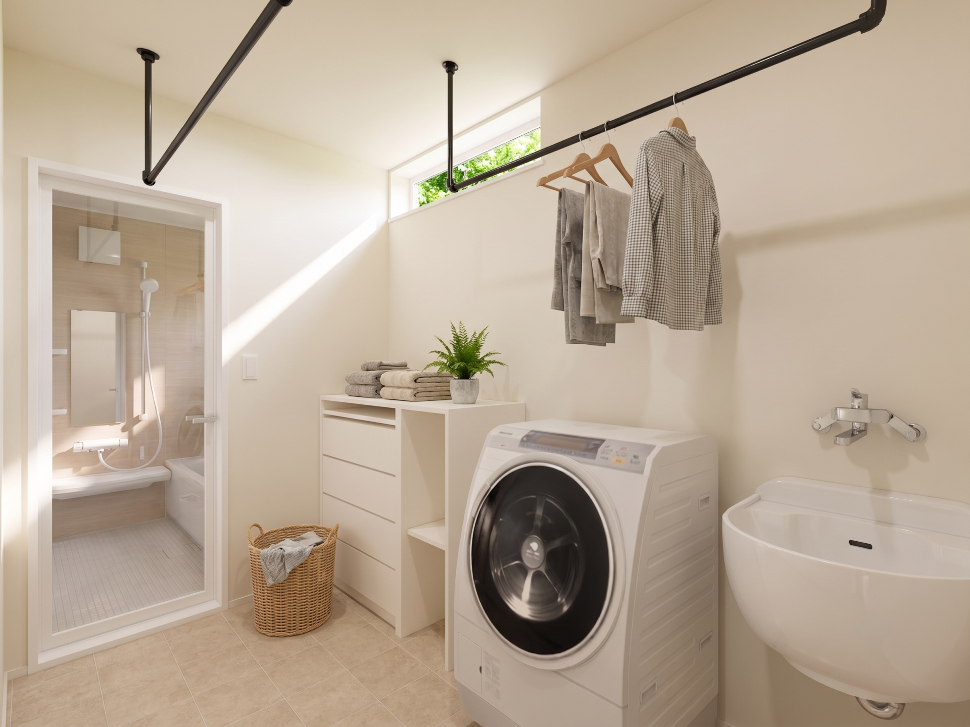 Laundry room with a front-loading washer and dryer, sink, and a clothing rail with shirts and towels; plant and wicker basket nearby